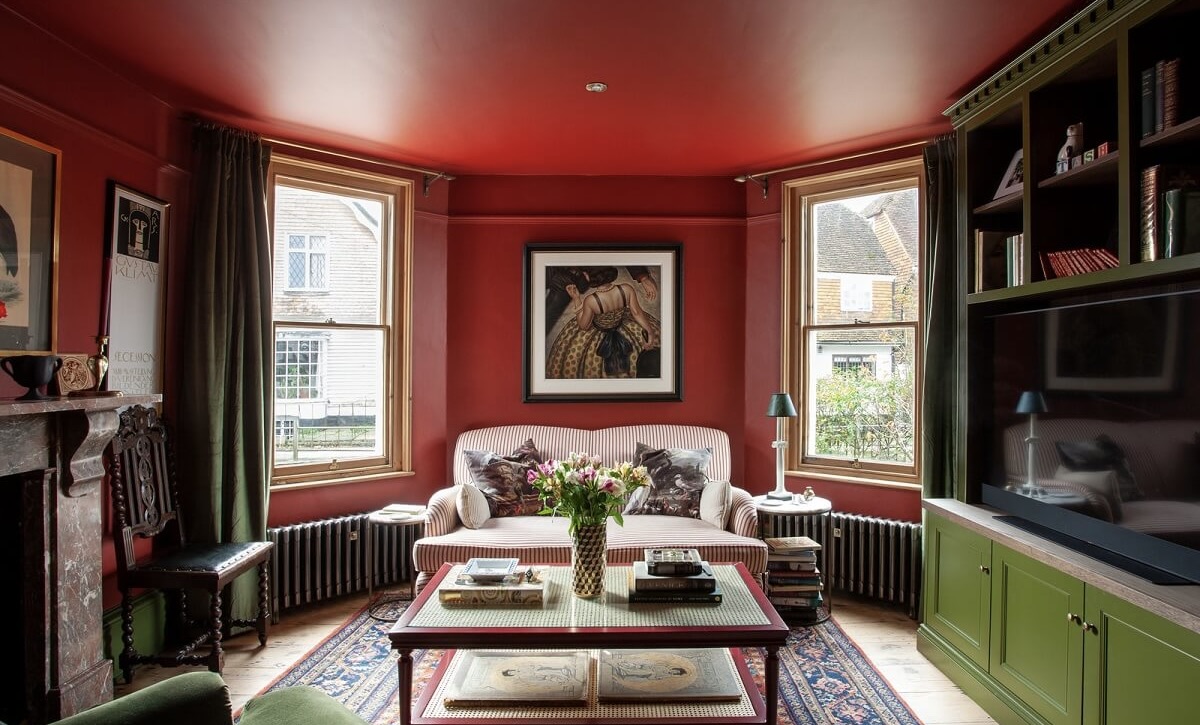 Viktoria ajastu stiilis võimsate värvitoonidega sisekujundus punaste seinte ja laega.